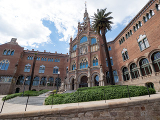 Fototapeta na wymiar Spain, may 2019: Hospital de la Santa Creu i Sant Pau - modernist building by famous architect Lluis Domenech i Montaner. Architecture of Barcelona inscribed on UNESCO World Heritage List.