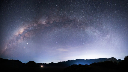 Beautiful night landscape with silhouette of Bromo mountain on the background Milky way galaxy -...