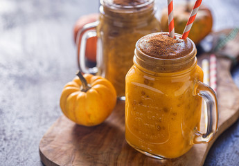 Pumpkin smoothie with cinnamon in a jar 