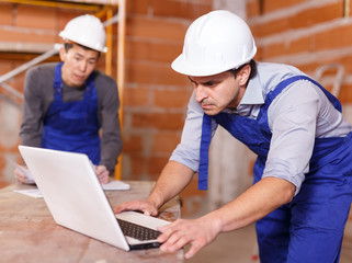 Professional builders using laptop
