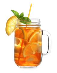 Mason jar of refreshing iced tea with lemon slices and mint on white background