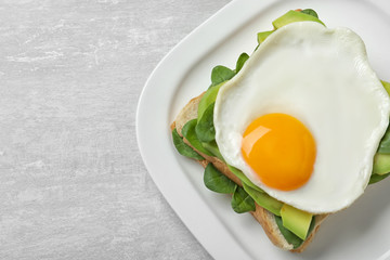 Delicious breakfast with fried egg served on table, top view. Space for text