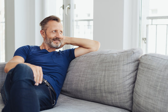 Attractive fit middle-aged man relaxing at home