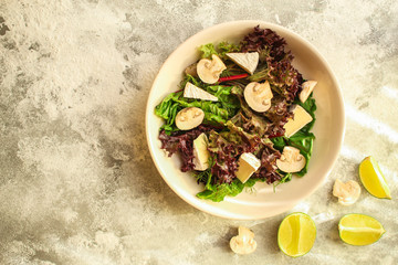 healthy salad mushrooms, cheese and green leaves (snack dish, vegetables, arugula, lettuce, spinach and more) menu concept. food background. copy space. Top view