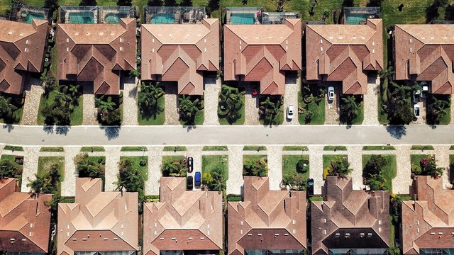Two rows of roofs on perfectly manicured homes