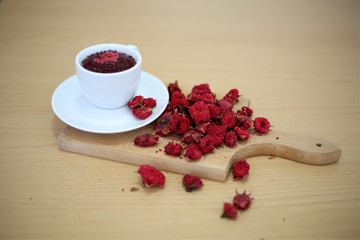 Pomegranate turkish tea in the white cup on the wooden background. Close up turkish tea.