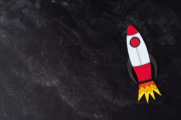 Boost or increase your income. Drawn rocket over dark background with copy space. Financial concept.