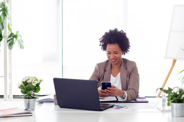 Typing message on mobile phone at the office