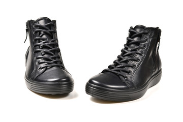 Men's black leather shoes and a black camera on a isolated on white background. Copy space.