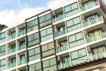 Modern condominium building in the city sky cloud background
