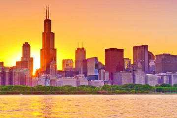 View of Chicago skyline from the shore of Lake Michigan at sunset.