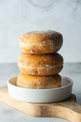 Fototapeta na wymiar Delicious sugar donuts on a white plate, rustic style.