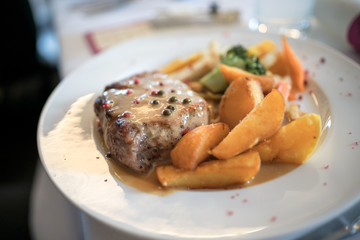 Chicken steak with wedges, vegetables and colorful pepper