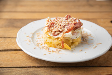 Spanish tapa, potato, fried egg, bacon and foie
