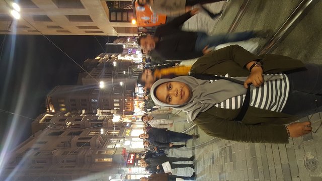 Young woman walking on street at night