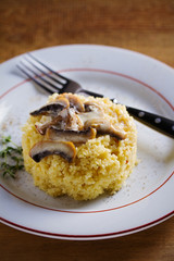 Couscous with mushrooms in cream sauce. Vertical image