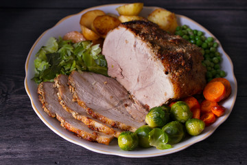 Roasted sliced ham and vegetables.