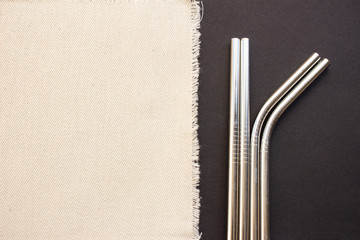 Metal straws on black background. Zero waste. Flat lay 