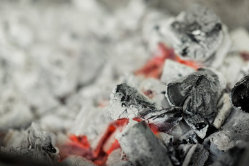 Close up of burnt black coal with red heat in brazier