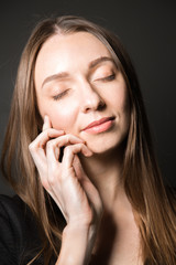 Beauty face portrait of young woman on a black background
