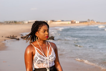 Young African Lady walking by the beach