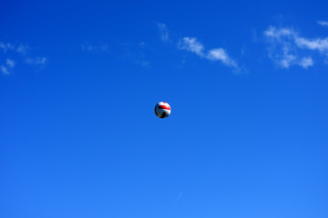 volleyball ball hovered in the air against the sky