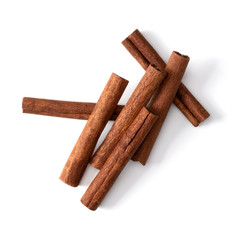 Cinnamon sticks isolated on white background closeup. Canella spice. Aromatic condiment background. Flat lay, top view.