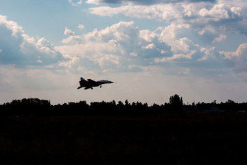military aircraft flying in the background of clouds