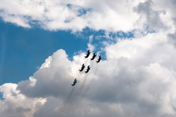 military aircraft flying in the background of clouds