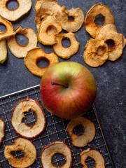 Dried slices of red and yellow apples, and fresh apple, rich in fiber and iron, healthy snack