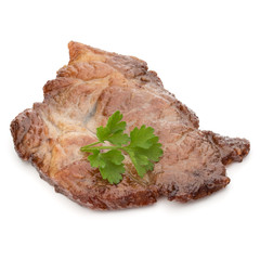 Cooked fried pork meat with parsley herb leaves garnish isolated on white background cutout