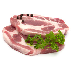 Raw pork neck chop meat with parsley herb leaves and peppercorn spices garnish isolated on white background cutout