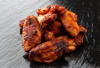 Fried wings close-up. Buffalo wings on a slate surface.