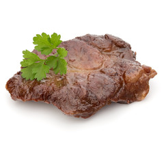 Cooked fried pork meat with parsley herb leaves garnish isolated on white background cutout