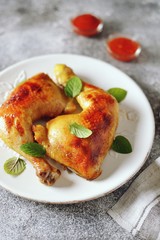 Roasted chicken legs with fresh mint.