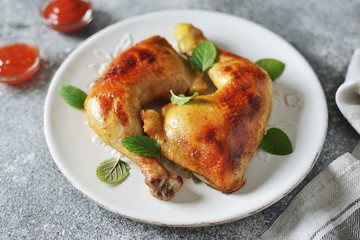 Roasted chicken legs with fresh mint.