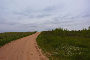 Lonely country squeaky road path among grasses nature landscape green sand