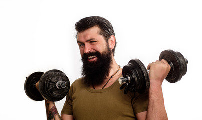 Fototapeta na wymiar Happy man with dumbbells. Bearded man with dumbbells during an exercise. Muscular fitness man making weightlifting. Strong handsome sportsman working out with dumbbells. Man raising dumbbells.