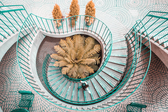 Overhead view of person walking on spiral stair