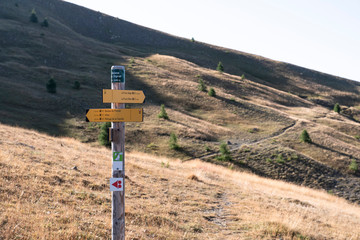 direction signs on hiking trails with place names noted on them, as well as the distance from these places