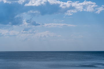 clear blue sea with beautiful sky with white clouds