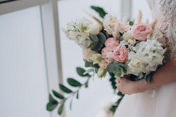 the bride in a white dress holding a bouquet of flowers