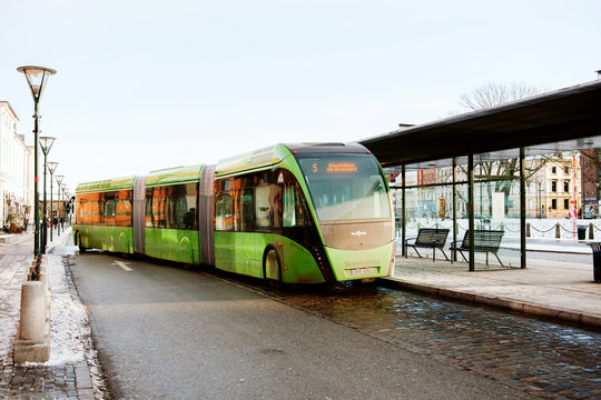 MALMO, SWEDEN - 29 DEC 2014: Green articulated bus Van Hool 324H Exequicity 24 Hybrid operated by Skanetrafiken arriving in bus station on a cold winter day - transportation line 5 in Malmo