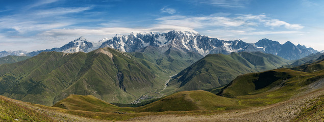 Fototapeta na wymiar view of main Caucasian ridge from Svanet ridge, panorama of Caucasus, view of mountains and mountain valley, village in mountains, Ushguli, Caucasus, Georgia