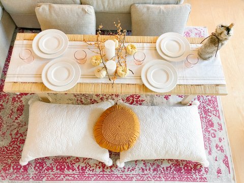 Rectangular brown wooden coffee table with white plates