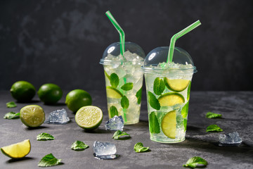 mojito cocktail  in plastic cup on a black background