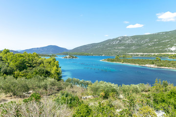 Fototapeta na wymiar Views of the Adriatic Sea - clear blue water, boat, rocky shore. Sea cruise in a paradise