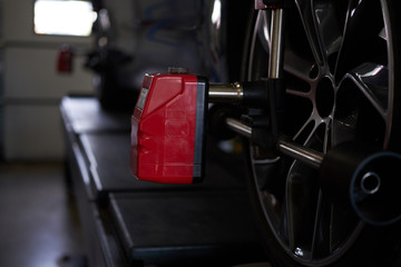 Fototapeta na wymiar Closeup photoshoot of process or tyre balancing at dark auto service.