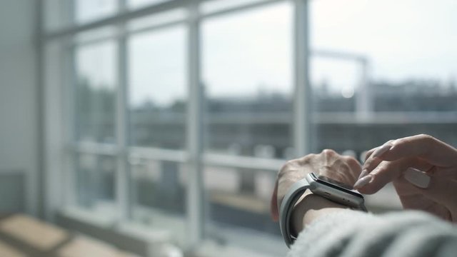 Woman using smartwatch touchscreen technology device. Woman making gestures on a wearable smart watch. Online banking. Easy pay using digital device. Communication via app for sale in shop. Close up