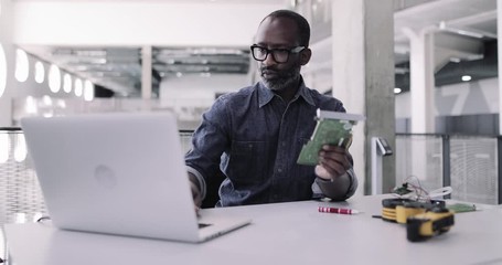 African American adult male working on robotics